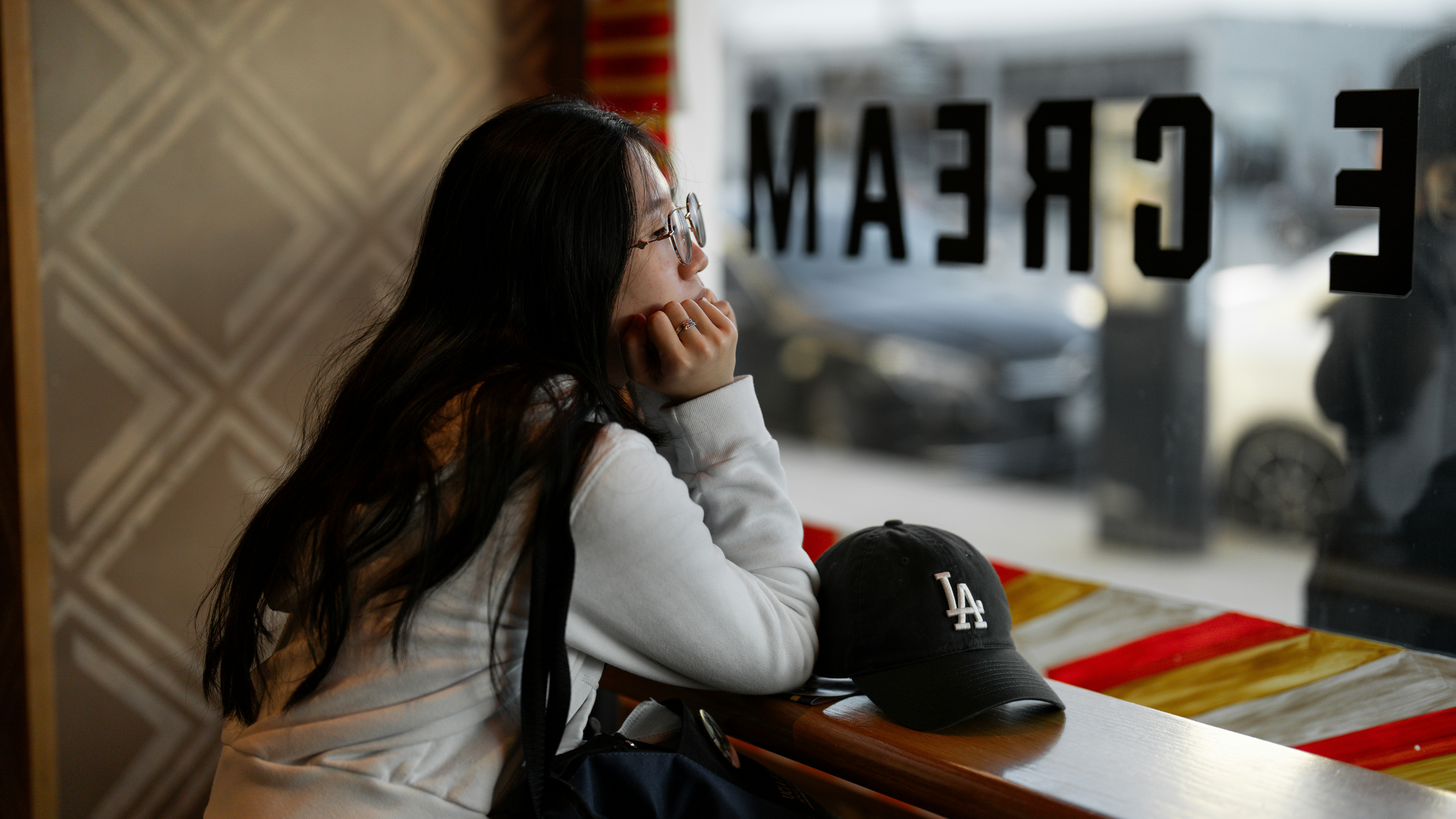 woman thinking coffee shop window contemplative