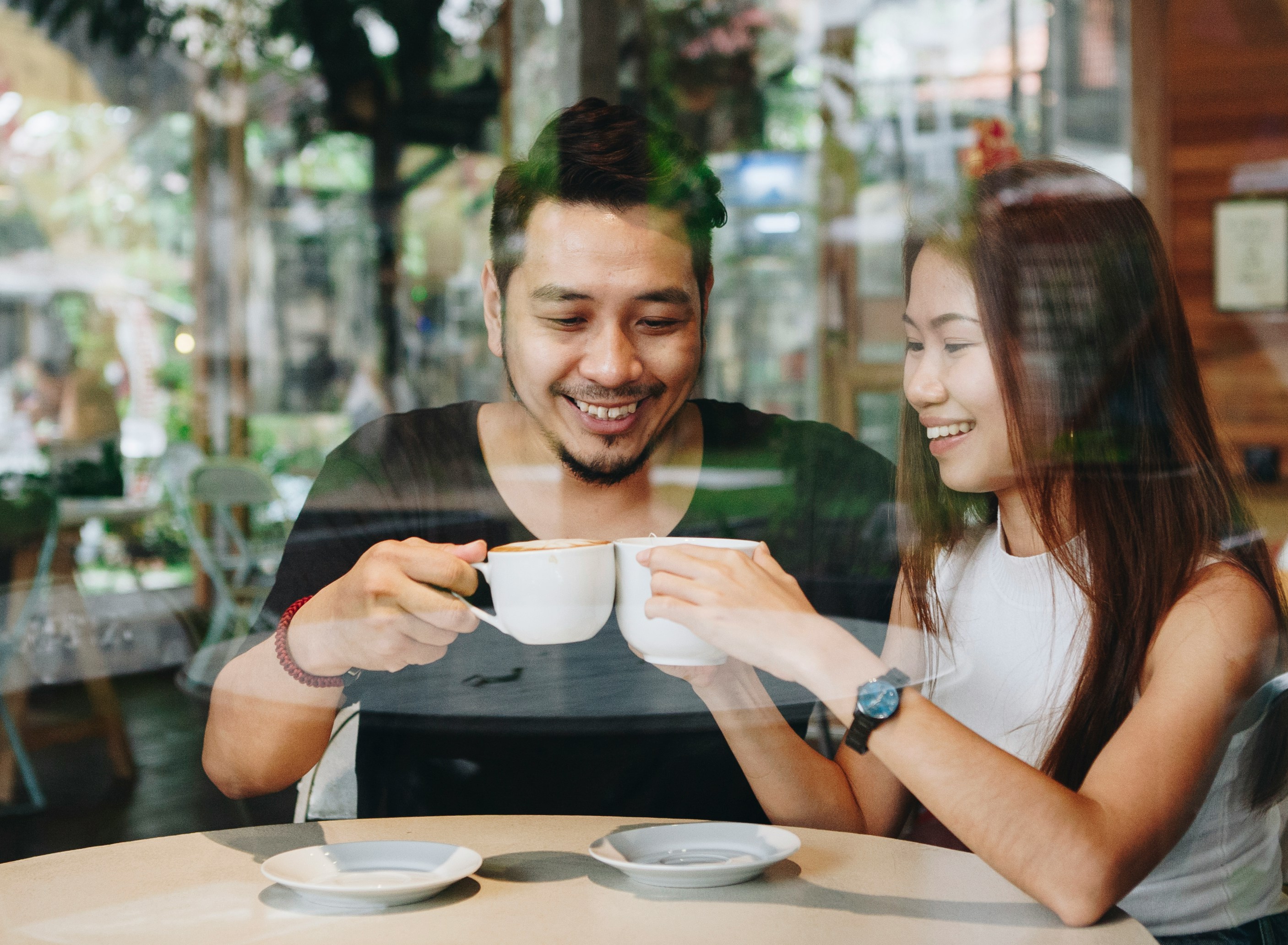 couple laughing coffee shop first date
